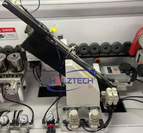 End Trimming.   The linear guide is located at an angle of 45° with 2 motors and 2 saw discs. To cut the extra banding tape in high precision.  
