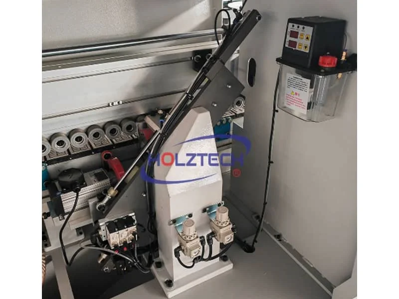 End Trimming.   The linear guide is located at an angle of 45° with 2 motors and 2 saw discs. To cut the extra banding tape in high precision.    Automatic lubrication system with adjustable frequency of lubricatant oil supply. 